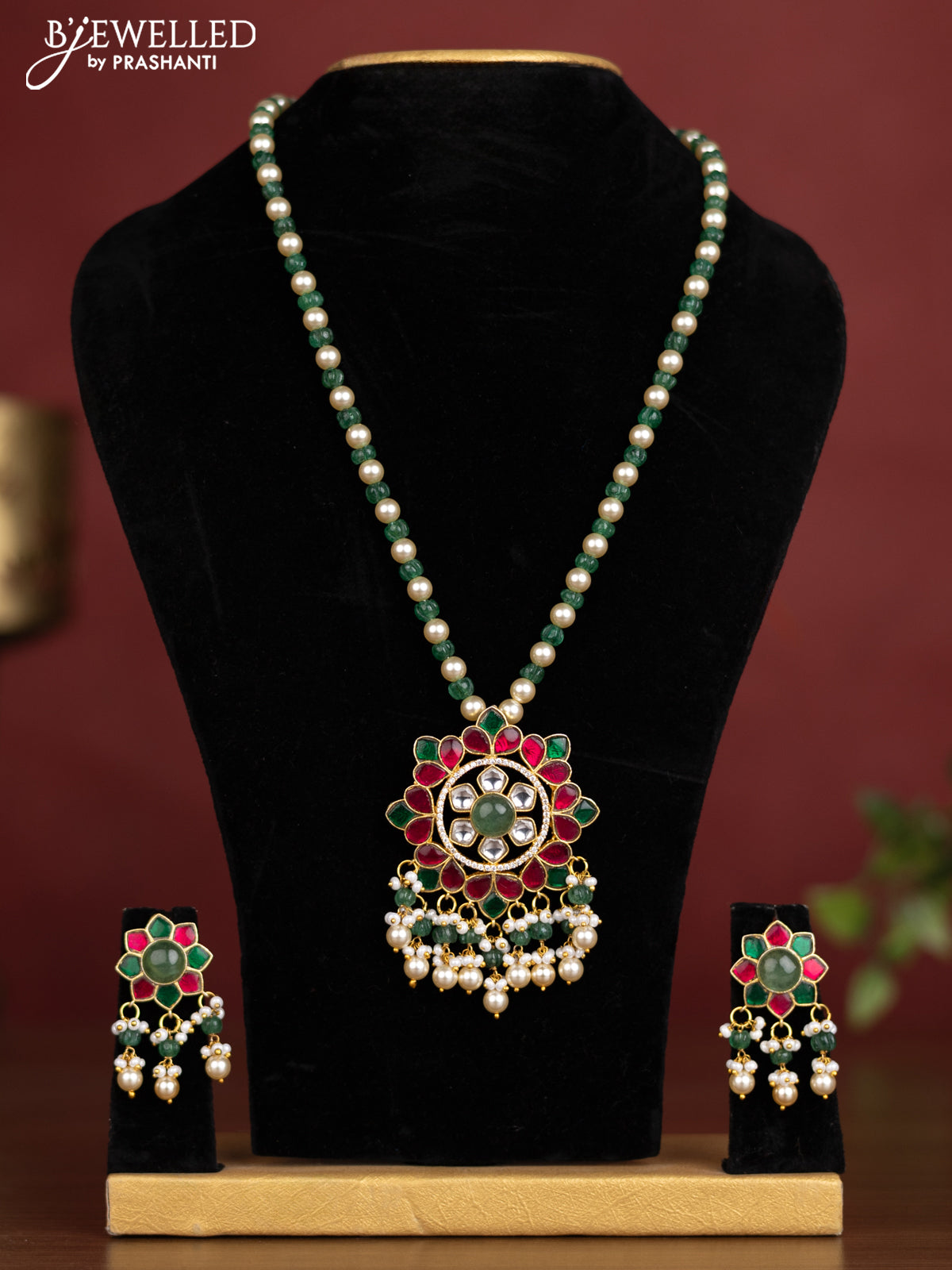 Antique beaded green and pearl necklace with a floral pendant, jadau kundan stones, and pearl & bead hangings