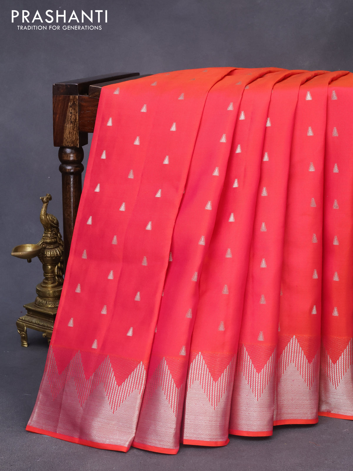 Pure kanchipuram silk saree dual shade of pinkish orange with silver zari woven buttas and silver zari woven border