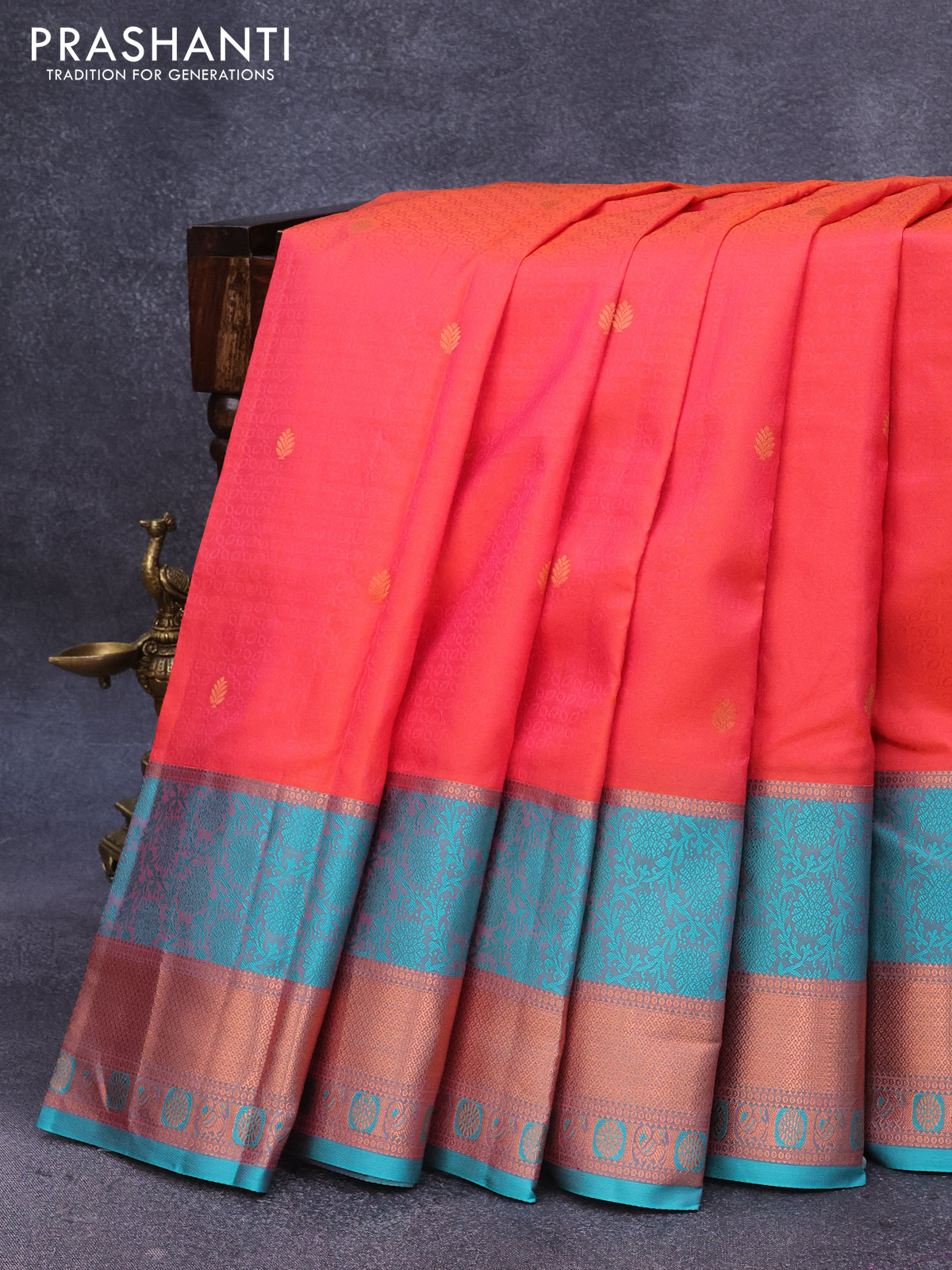 Pure kanjivaram silk saree dual shade of orange and teal green with allover self emboss & copper zari buttas and rettapet copper zari woven border