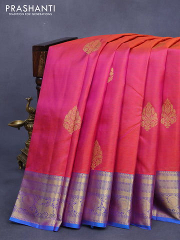 Pure kanjivaram silk saree dual shade of pinkish orange and dual shade of cs blue with allover zari weaves & buttas and zari woven annam border