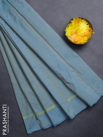 Arani semi silk saree teal blue shade with allover small zari checked pattern and zari woven simple border