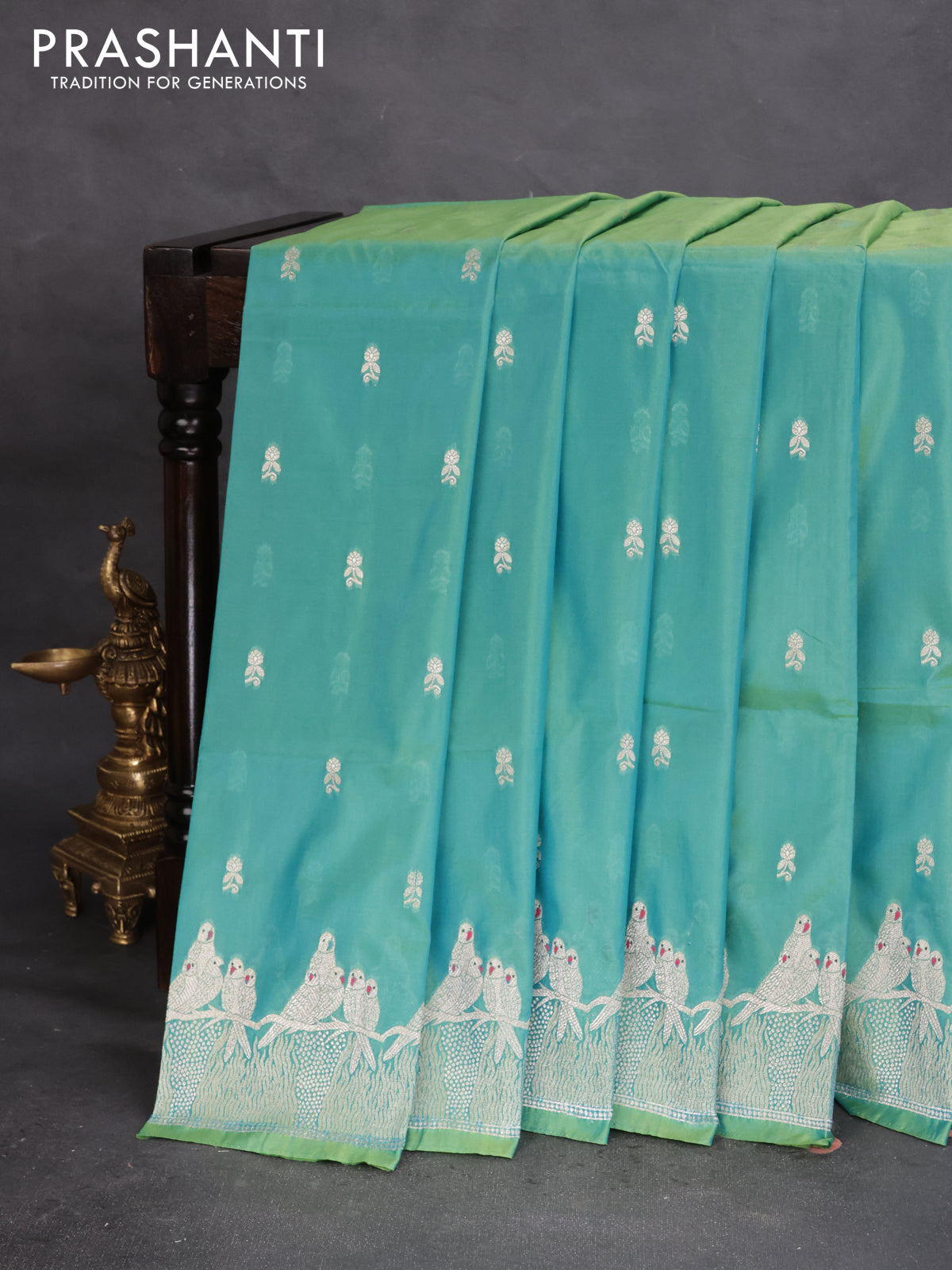 Banarasi semi katan silk saree dual shade of teal bluish green with allover zari woven buttas and parrot design zari woven border