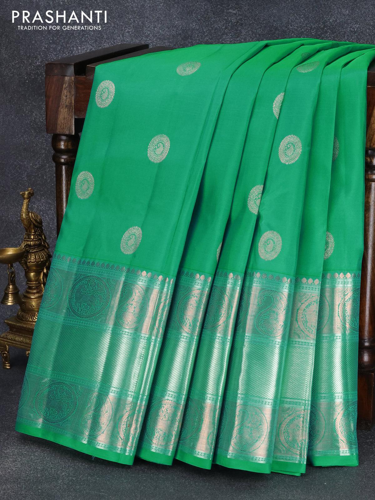 Pure kanjivaram silk saree dual shade of teal green and dual shade of pinkish orange with zari woven buttas and long rich zari woven border